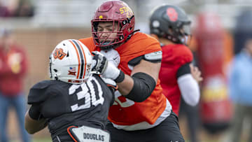 National team offensive lineman Jalen Travis of Iowa State (72) works against National team defensive lineman Collin Oliver of Oklahoma State (30) during Senior Bowl practice for the National team at Hancock Whitney Stadium.