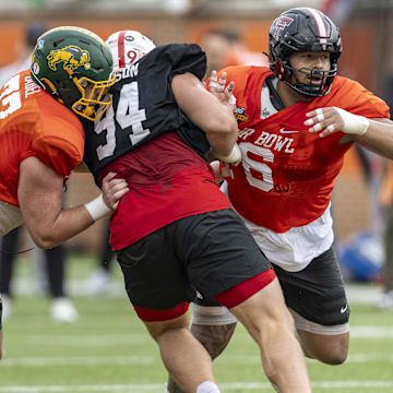 Jan 30, 2025; Mobile, AL, USA; National team offensive lineman Grey Zabel of North Dakota State (77) and National team offensive lineman Caleb Rogers of Texas Tech (76) battle with National team defensive lineman Ty Robinson of Nebraska (94) during Senior Bowl practice for the National team at Hancock Whitney Stadium. Mandatory Credit: Vasha Hunt-Imagn Images