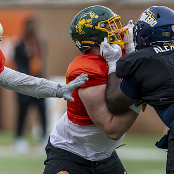 Jan 30, 2025; Mobile, AL, USA; National team offensive lineman Grey Zabel of North Dakota State (77) works against National team defensive lineman Darius Alexander of Toledo (9) during Senior Bowl practice for the National team at Hancock Whitney Stadium. Mandatory Credit: Vasha Hunt-Imagn Images