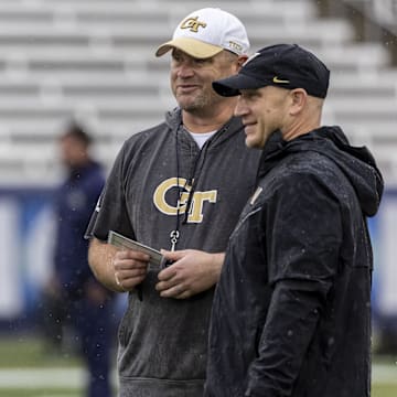 Dec 27, 2024; Birmingham, AL, USA;  Georgia Tech Yellow Jackets head coach Brent Key, left, talks with Vanderbilt Commodores head coach Clark Lea during warm-ups before the 2024 Birmingham Bowl at Protective Stadium. Mandatory Credit: Vasha Hunt-Imagn Images