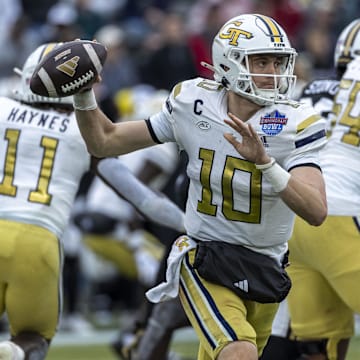 Dec 27, 2024; Birmingham, AL, USA;  Georgia Tech Yellow Jackets quarterback Haynes King (10) throws the ball on the run against the Vanderbilt Commodores during the first half of the 2024 Birmingham Bowl at Protective Stadium. Mandatory Credit: Vasha Hunt-Imagn Images