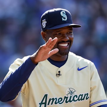 American League Futures manager Harold Reynolds high-fives a player following the third inning of the All Star-Futures Game at T-Mobile Park in 2023.