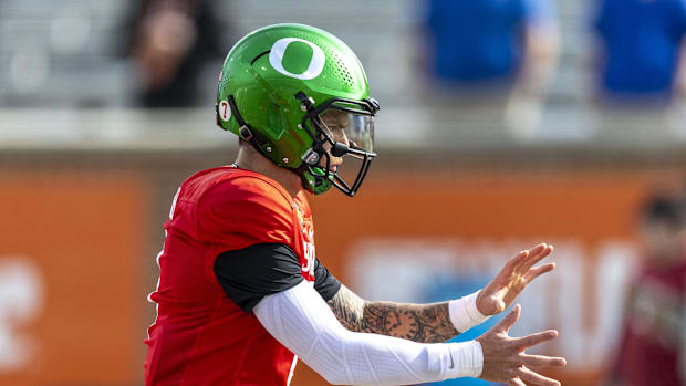 Jan 28, 2025; Mobile, AL, USA; National team quarterback Dillon Gabriel of Oregon (8) runs a play during Senior Bowl practice