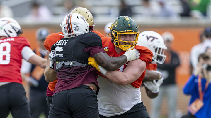 Jan 30, 2025; Mobile, AL, USA; National team defensive lineman Aeneas Peebles of Virginia Tech (16) battles National team offensive lineman Grey Zabel of North Dakota State (77) during Senior Bowl practice for the National team at Hancock Whitney Stadium. Mandatory Credit: Vasha Hunt-Imagn Images