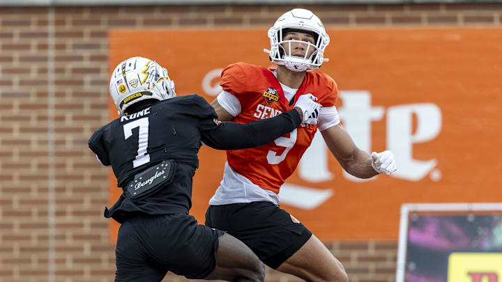 Jayden Higgins of Iowa State (9) tracks a pass against defensive back Bilhal Kone of Western Michigan at the Senior Bowl.