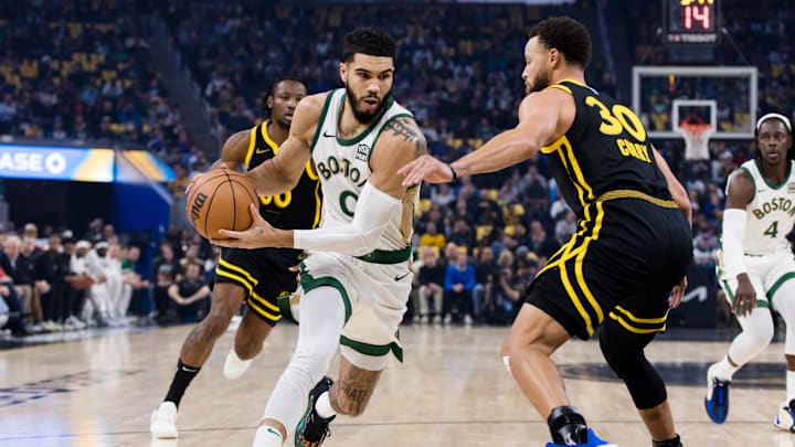 Boston Celtics forward Jayson Tatum (0) drives past Golden State Warriors guard Stephen Curry. Boston Celtics forward Jayson Tatum (0) drives past Golden State Warriors guard Stephen Curry.