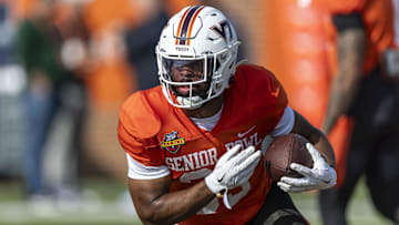 Jan 29, 2025; Mobile, AL, USA; National team running back Bhayshul Tuten of Virginia Tech (33) runs the ball during Senior Bowl practice for the National team at Hancock Whitney Stadium. Mandatory Credit: Vasha Hunt-Imagn Images
