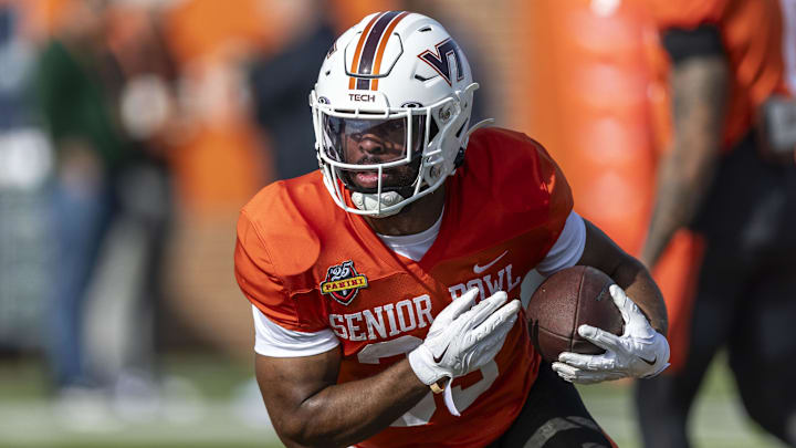 Jan 29, 2025; Mobile, AL, USA; National team running back Bhayshul Tuten of Virginia Tech (33) runs the ball during Senior Bowl practice for the National team at Hancock Whitney Stadium. Mandatory Credit: Vasha Hunt-Imagn Images