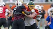 National team DL Aeneas Peebles of Virginia Tech (16) battles National team OL Grey Zabel of North Dakota State (77) during Senior Bowl practice