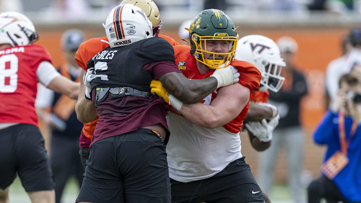 National team DL Aeneas Peebles of Virginia Tech (16) battles National team OL Grey Zabel of North Dakota State (77) during Senior Bowl practice National team DL Aeneas Peebles of Virginia Tech (16) battles National team OL Grey Zabel of North Dakota State (77) during Senior Bowl practice