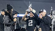 Vanderbilt Commodores quarterback Diego Pavia hoists the MVP trophy against the Georgia Tech Yellow Jackets