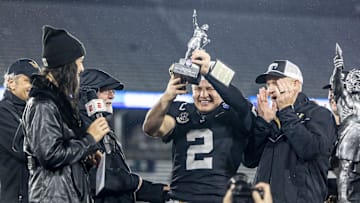 Vanderbilt Commodores quarterback Diego Pavia hoists the MVP trophy against the Georgia Tech Yellow Jackets