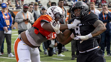 Jan 28, 2025; Mobile, AL, USA; American team offensive lineman Carson Vinson of Alabama A&M (76) spars with American team defensive lineman Kyle Kennard of South Carolina (9) during Senior Bowl practice for the American team at Hancock Whitney Stadium. Mandatory Credit: Vasha Hunt-Imagn Images