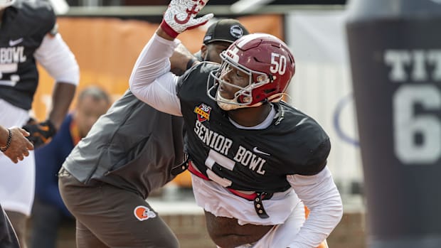 Colts defensive tackle Tim Smith (red helmet) rips through a block during the Senior Bowl practices.