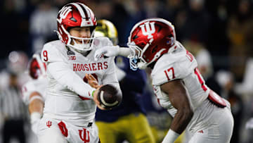 Indiana quarterback Kurtis Rourke (9) hands the ball off to running back Ty Son Lawton (17) during the first round of the College Football Playoff between Notre Dame and Indiana at Notre Dame Stadium on Friday, Dec. 20, 2024, in South Bend.