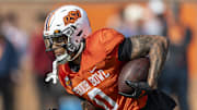 Jan 29, 2025; Mobile, AL, USA; National team running back Ollie Gordon II of Oklahoma State (0) runs the ball during Senior Bowl practice for the National team at Hancock Whitney Stadium. Mandatory Credit: Vasha Hunt-Imagn Images