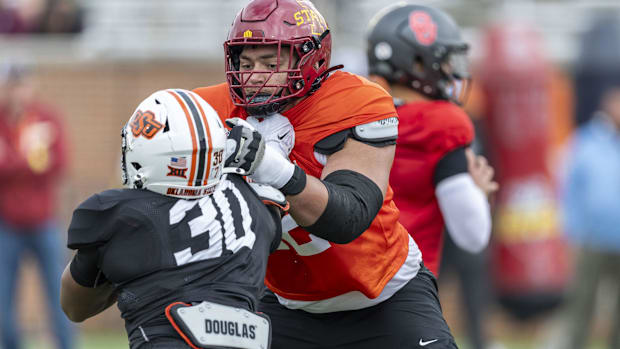 Colts offensive tackle Jalen Travis (maroon helmet) blocks a player during the Senior Bowl.