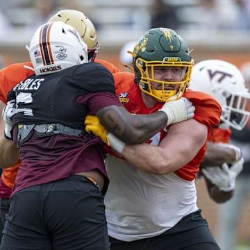 Jan 30, 2025; Mobile, AL, USA; National team defensive lineman Aeneas Peebles of Virginia Tech (16) battles National team offensive lineman Grey Zabel of North Dakota State (77) during Senior Bowl practice for the National team at Hancock Whitney Stadium. Mandatory Credit: Vasha Hunt-Imagn Images