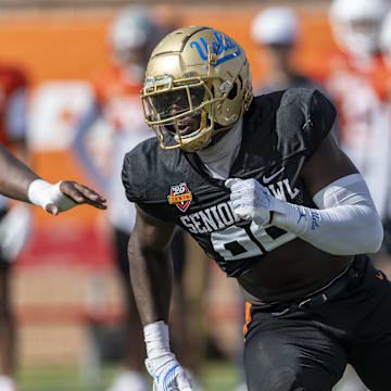 Jan 29, 2025; Mobile, AL, USA; National team defensive lineman Oluwafemi Oladejo of UCLA (99) runs through a drill during Senior Bowl practice at Hancock Whitney Stadium. Mandatory Credit: Vasha Hunt-Imagn Images