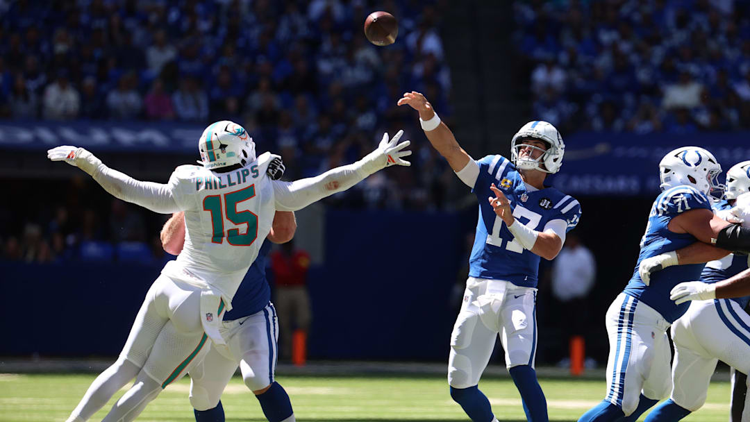 Sep 7, 2025; Indianapolis, Indiana, USA; Indianapolis Colts quarterback Daniel Jones (17) throws a touchdown against Miami Dolphins linebacker Jaelan Phillips (15) during the first half at Lucas Oil Stadium. Mandatory Credit: Trevor Ruszkowski-Imagn Images