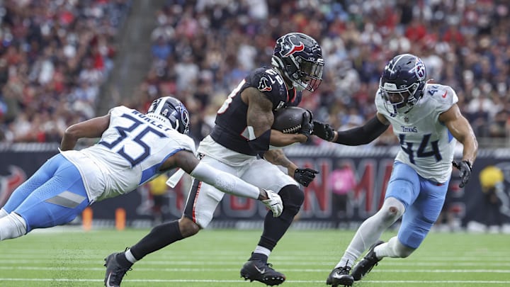Nov 24, 2024; Houston, Texas, USA; Houston Texans running back Joe Mixon (28) runs with the ball as Tennessee Titans cornerback Daryl Worley (35) attempts to make a tackle during the fourth quarter at NRG Stadium. Mandatory Credit: Troy Taormina-Imagn Images Nov 24, 2024; Houston, Texas, USA; Houston Texans running back Joe Mixon (28) runs with the ball as Tennessee Titans cornerback Daryl Worley (35) attempts to make a tackle during the fourth quarter at NRG Stadium. Mandatory Credit: Troy Taormina-Imagn Images