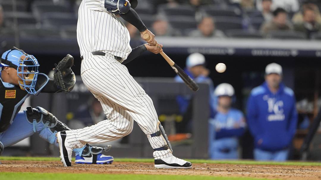 Apr 14, 2025; Bronx, New York, USA; New York Yankees center fielder Trent Grisham (12) hits a home run against the Kansas City Royals during the fifth inning at Yankee Stadium. 