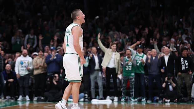 Boston Celtics guard Payton Pritchard (11) reacts after a shot during the second half against the Milwaukee Bucks 