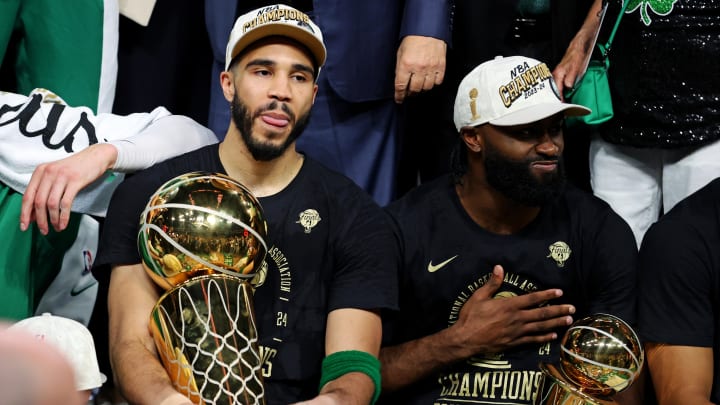 Jun 17, 2024; Boston, Massachusetts, USA; Boston Celtics forward Jayson Tatum (0) and guard Jaylen Brown (7) celebrates with the Larry O’Brian Trophy after beating the Dallas Mavericks in game five of the 2024 NBA Finals to win the NBA Championship at TD Garden. Mandatory Credit: Peter Casey-USA TODAY Sports