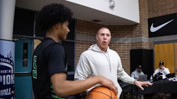 Mike Bibby talks to Arizona Compass Prep guard Kalek House against CIA Bella Vista during the Hoophall West High School Invitational at Highland High School. 