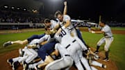 Jun 2, 2025; Oxford, MS, USA; The Murray State Racers dog pile on the mound after defeating the Mississippi Rebels in the Oxford Regional. Mandatory Credit: Petre Thomas-Imagn Images