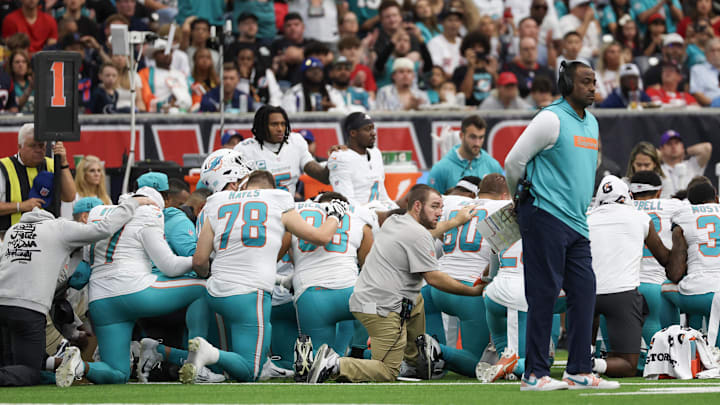 The Miami Dolphins pray on the sidelines as the medical team works on wide receiver Grant DuBose after taking a hit against the Houston Texans. The Miami Dolphins pray on the sidelines as the medical team works on wide receiver Grant DuBose after taking a hit against the Houston Texans.