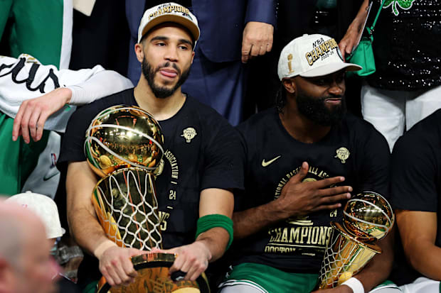 Boston Celtics Jayson Tatum and Jaylen Brown hold the Larry O’Brien and Finals MVP trophies after winning the NBA Finals.