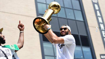 Jun 21, 2024; Boston, MA, USA;  Boston Celtics player Jayson Tatum holds the Larry OíBrien trophy during the Boston Celtics Championship parade. Mandatory Credit: Bob DeChiara-USA TODAY Sports