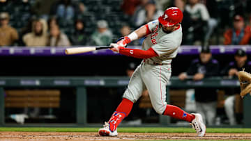  Philadelphia Phillies designated hitter Kyle Schwarber (12) hits a solo home run in the ninth inning against the Colorado Rockies at Coors Field. 