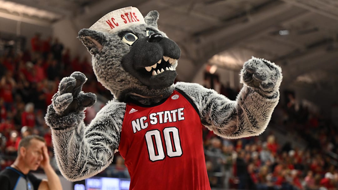 Mar 24, 2025; Raleigh, North Carolina, USA; The NC State Wolfpack mascot celebrates during the second half at James T. Valvano Arena at William Neal Reynolds. Mandatory Credit: William Howard-Imagn Images
