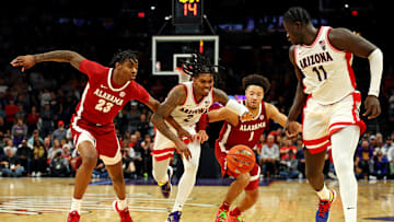 Dec 20, 2023; Phoenix, Arizona, USA; Arizona Wildcats guard Caleb Love (2) goes for the ball against Alabama Crimson Tide forward Nick Pringle (23) and guard Mark Sears (1) during the second half in the Hall of Fame Series at Footprint Center. Mandatory Credit: Mark J. Rebilas-Imagn Images