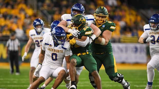 North Dakota State Bison running back CharMar Brown (25) gets tackled by South Dakota State defense on Saturday, Dec. 21, 202