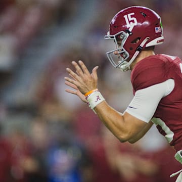 Aug 31, 2024; Tuscaloosa, Alabama, USA;  Alabama Crimson Tide quarterback Ty Simpson (15) reaches out for a snap during the fourth quarter at Bryant-Denny Stadium. 