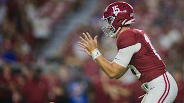 Aug 31, 2024; Tuscaloosa, Alabama, USA;  Alabama Crimson Tide quarterback Ty Simpson (15) reaches out for a snap during the fourth quarter at Bryant-Denny Stadium. Mandatory Credit: Will McLelland-Imagn Images