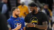 Dec 25, 2024; San Francisco, California, USA; Golden State Warriors guard Stephen Curry (left) and Los Angeles Lakers forward LeBron James (right) talk before the game at Chase Center. Mandatory Credit: Darren Yamashita-Imagn Images