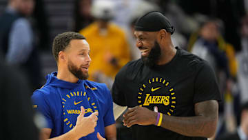 Dec 25, 2024; San Francisco, California, USA; Golden State Warriors guard Stephen Curry (left) and Los Angeles Lakers forward LeBron James (right) talk before the game at Chase Center. Mandatory Credit: Darren Yamashita-Imagn Images