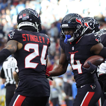 Jan 11, 2025; Houston, Texas, USA; Houston Texans corner back Kamari Lassiter (4) celebrates an intercaption during the second quarter against the Los Angeles Chargers in an AFC wild card game at NRG Stadium. Mandatory Credit: Troy Taormina-Imagn Images