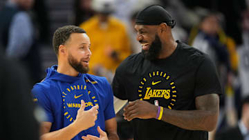 Dec 25, 2024; San Francisco, California, USA; Golden State Warriors guard Stephen Curry (left) and Los Angeles Lakers forward LeBron James (right) talk before the game at Chase Center. 