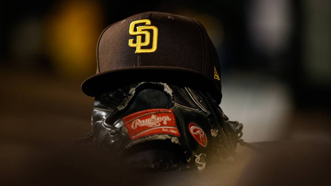Jun 17, 2022; Denver, Colorado, USA; A detail view of a San Diego Padres hat on a glove in the dugout in the ninth inning against the Colorado Rockies at Coors Field. Mandatory Credit: Isaiah J. Downing-USA TODAY Sports