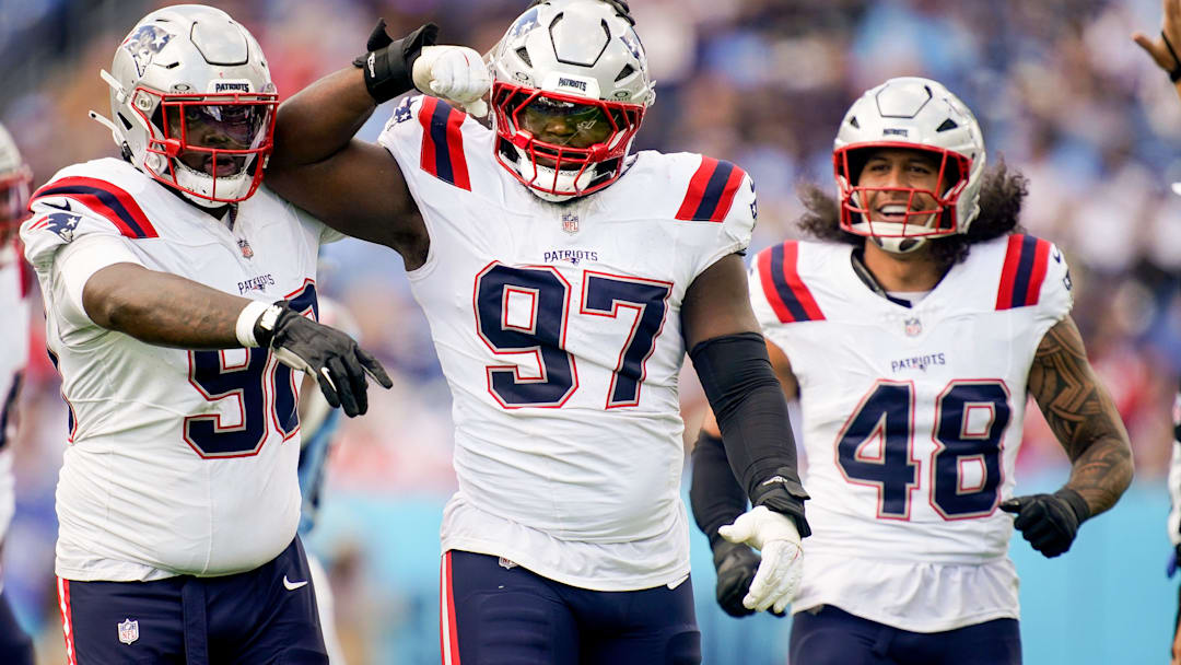 New England Patriots defensive end Milton Williams (97) celebrates sacking Tennessee Titans quarterback Cam Ward (1) during the third quarter at Nissan Stadium in Nashville, Tenn., Sunday, Oct. 19, 2025.