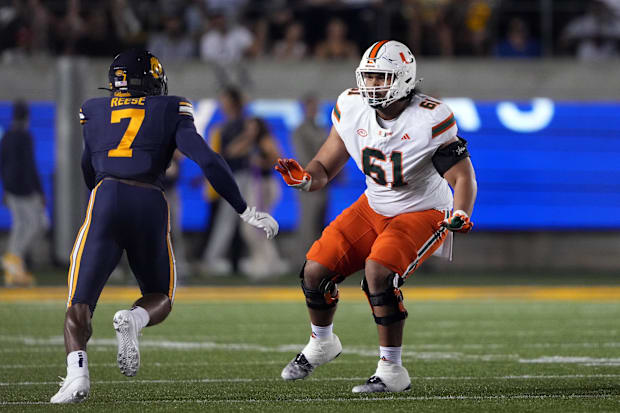 Miami Hurricanes offensive lineman Francis Mauigoa blocks against California Golden Bears linebacker David Reese.