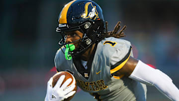 American Heritage Patriots receiver Malachi Toney (1) runs the ball during the first quarter of a game against the Naples Golden Eagles at Staver Field in Naples on Friday, Sept. 13, 2024.