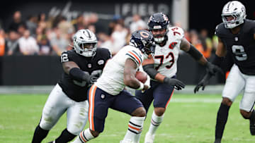 Sep 28, 2025; Paradise, Nevada, USA; Chicago Bears running back d'Andre Swift (4) is pressed by Las Vegas Raiders defensive tackle JJ Pegues (92) during the second quarter at Allegiant Stadium. Mandatory Credit: Kiyoshi Mio-Imagn Images