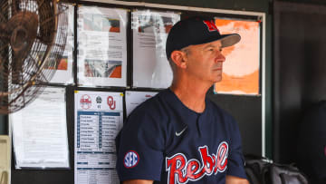 Jun 26, 2022; Omaha, NE, USA; Ole Miss Head Coach Mike Bianco sits in the dugout just before the first inning against the Oklahoma Sooners at Charles Schwab Field. Mandatory Credit: Jaylynn Nash-USA TODAY Sports