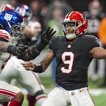 Dec 22, 2024; Atlanta, Georgia, USA; Atlanta Falcons quarterback Michael Penix Jr. (9) passes under pressure from New York Giants linebacker Kayvon Thibodeaux (5) during the first quarter at Mercedes-Benz Stadium. Mandatory Credit: Dale Zanine-Imagn Images